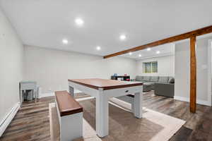Dining space featuring recessed lighting, baseboard heating, wood finished floors, and beamed ceiling