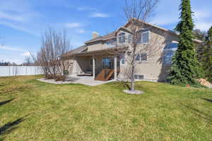 Back of property with a patio, stucco siding, and a chimney