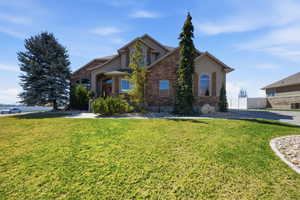 View of front of house featuring stone siding and stucco siding