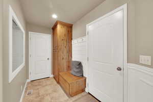 Mudroom with recessed lighting and light tile patterned flooring