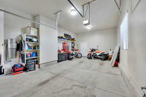 Garage with a central vacuum unit and a garage door opener