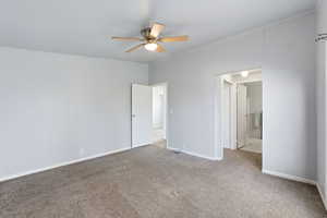 Unfurnished bedroom with carpet floors, ceiling fan, ensuite bath, and ornamental molding