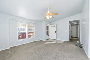 Unfurnished bedroom with carpet floors, a ceiling fan, and vaulted ceiling