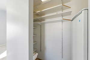 View of walk in closet, storage off Kitchen