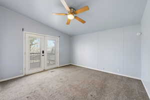 Primary Bedroom. Carpeted spare room with a ceiling fan, french doors, and vaulted ceiling. Deck off with view of  River