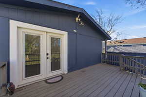 Deck off Primary Suite featuring French doors