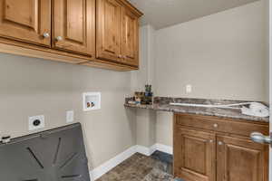 Laundry area with pantry; hookup for a washing machine, cabinet space, electric dryer hookup, and a textured ceiling