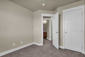 Unfurnished bedroom featuring carpet floors and baseboards