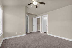 Master with ceiling fan, lofted ceiling, and carpet floors