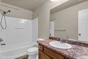 Bathroom featuring vanity and washtub / shower combination