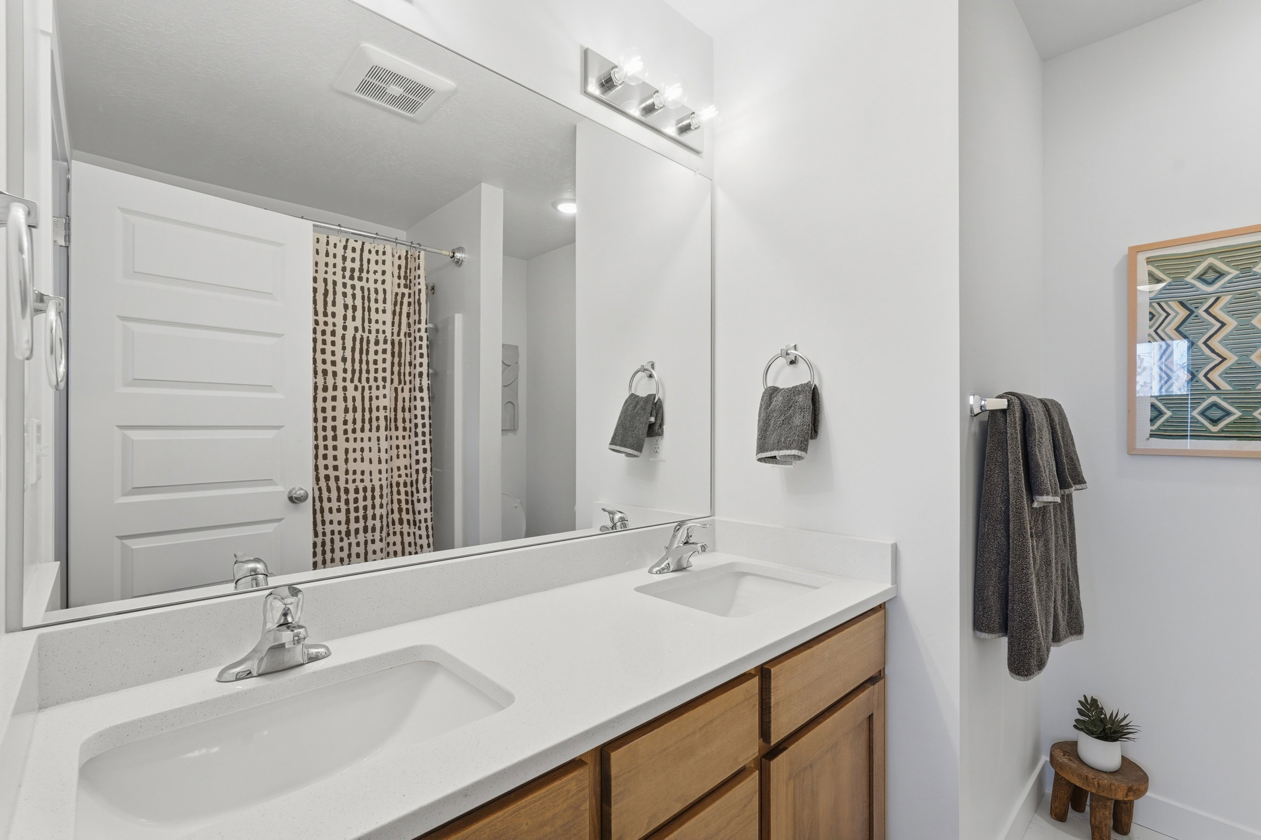 Primary bathroom featuring double sinks and quartz countertops