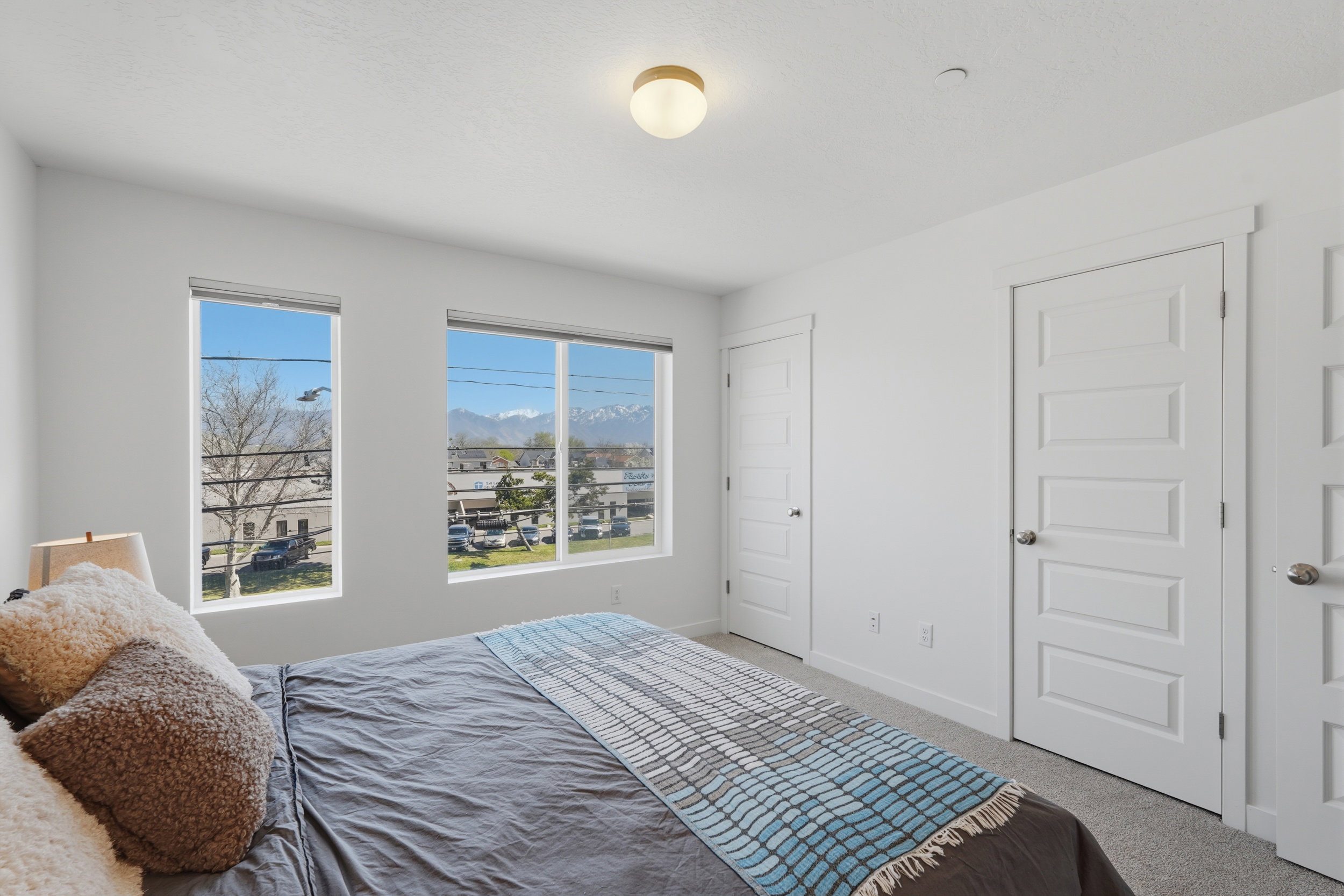 Carpeted bedroom with a mountain view and baseboards