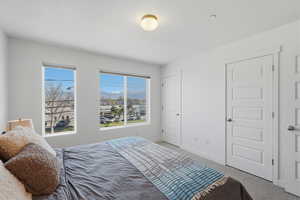 Carpeted bedroom with a mountain view and baseboards