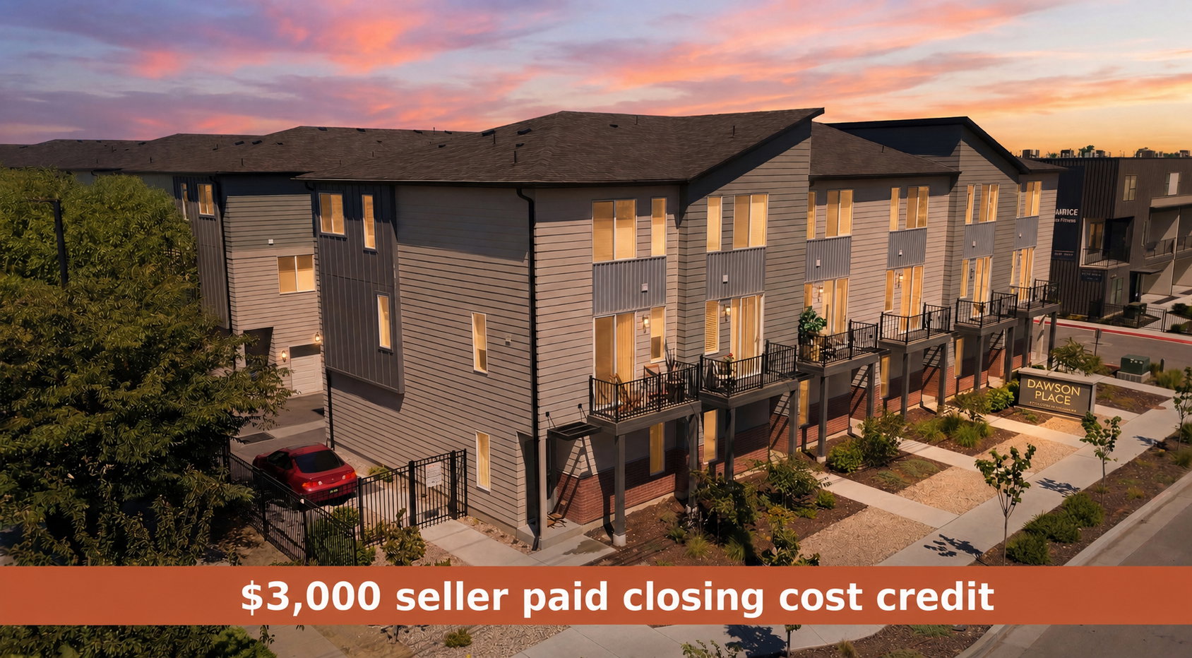 Modern townhome community featuring multi-level units with private balconies, contemporary siding, and individual ground-level entrances