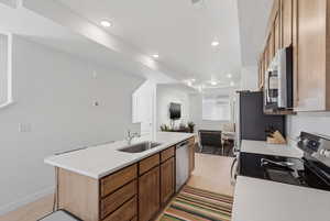Kitchen with wood shaker-style cabinetry, quartz countertops, and stainless steel appliances. The 8-foot kitchen island is perfect for extra seating and entertaining.