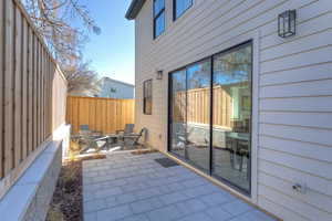 Fenced backyard with a patio and a fire pit