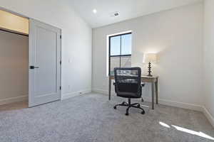 Office area with light colored carpet and recessed lighting