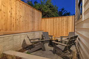 Fenced backyard featuring a patio area and an outdoor fire pit