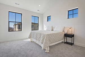 Bedroom with lofted ceiling, carpet flooring, and recessed lighting