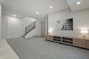 Unfurnished living room with recessed lighting and light colored carpet