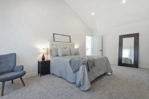 Bedroom with light carpet, vaulted ceiling, and recessed lighting
