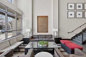 Living area with a high ceiling and stairway