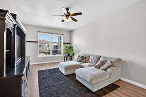 Living area featuring light wood finished floors and ceiling fan