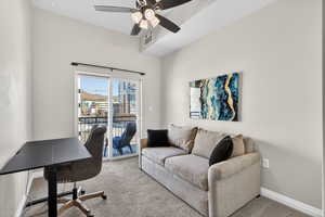 Home office featuring carpet floors and a ceiling fan