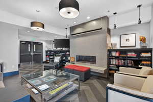 Living room with a fireplace, recessed lighting, and parquet flooring