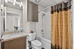 Full bathroom with shower / bath combo and vanity