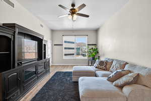 Living room featuring a ceiling fan and light wood-type flooring