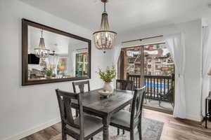 Dining area with deck access and view of community pool.