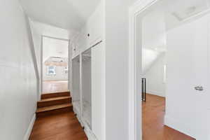 Hallway with light wood-type flooring and attic access