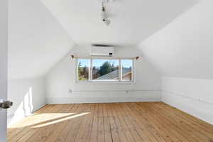 Bonus room featuring light wood finished floors and baseboards