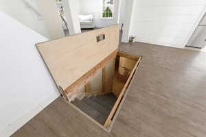 Staircase featuring wood finished floors and baseboards