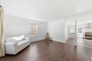 Sitting room featuring dark wood-style floors