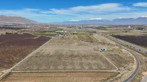 Overview of rural landscape with farmland and a mountainous background