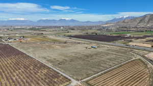 Overview of rural landscape featuring abundant farmland and a mountain backdrop