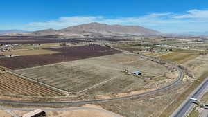 Aerial view of sparsely populated area featuring abundant farmland and a mountainous background