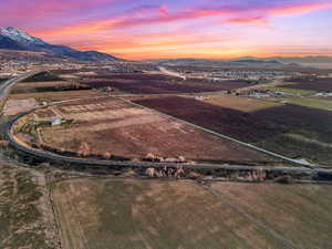 Aerial view of sparsely populated area with abundant farmland and a mountain backdrop