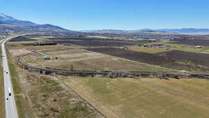 Aerial view of property's location featuring rural landscape, a mountainous background, and farmland