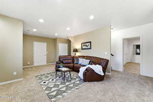 Living area featuring recessed lighting and light colored carpet