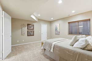 Bedroom featuring light colored carpet and recessed lighting