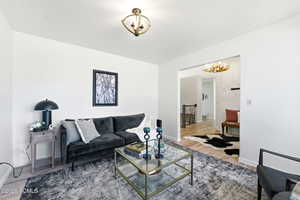 Living room featuring wood finished floors and hanging lights