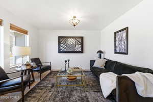 Living area with wood finished floors and baseboards