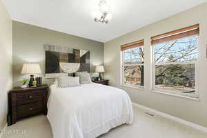 Carpeted bedroom featuring baseboards