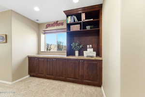 Office with light colored carpet and recessed lighting