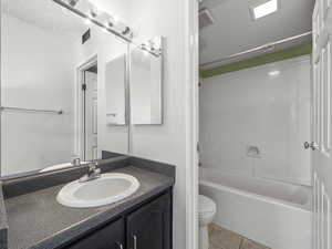 Full bathroom featuring vanity, tub / shower combination, and light tile patterned floors