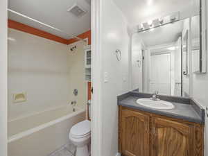 Bathroom with vanity, tub / shower combination, and light tile patterned floors