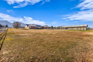 View of yard featuring a mountain view and an outdoor structure